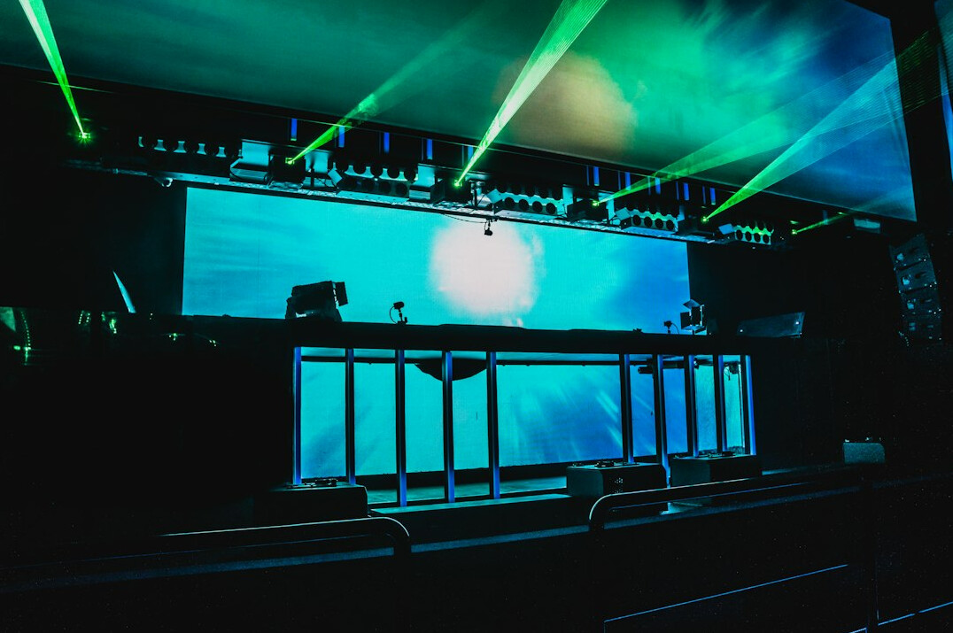 Stage with lighting rigs and screens at a live event