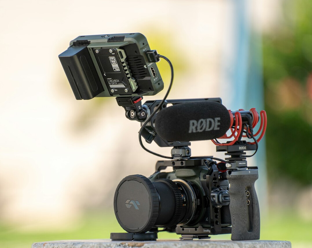 Video camera on a shoulder rig with monitor